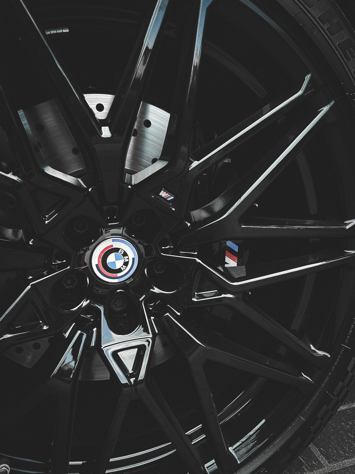 Black and white BMW M Sport wheel featuring iconic badge representing professional logo design and brand identity for Long Island businesses